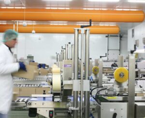 Packaging process in a factory setting.