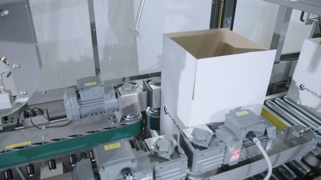 Case entering the gluing section of the Endoline 407 Random Case Gluer